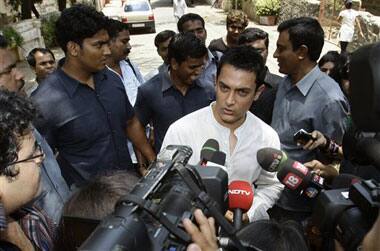 Bollywood actor Aamir Khan speaks to journalists before casting his vote at a polling station in Mumbai