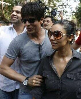 Bollywood star Shahrukh Khan (C) arrives with wife Gauri to cast their votes at a polling centre in Mumbai 