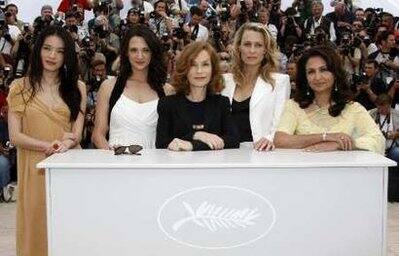 Jury members of the 62nd Cannes Film Festival stand with jury president and French actress Isabelle Huppert (C) during a photocall at the 62nd Cannes Film Festival May 13, 2009. Jury members are (from