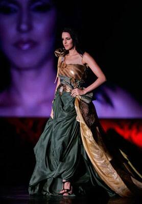 Bollywood actress Dhupia Neha displays a creation from D 'damas at the Fashion Extravaganza one day before the 10th International Indian Film Awards presentation at a casino-hotel complex in Macau.