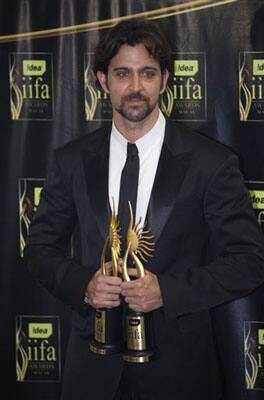 Indian actor Hrithik Roshan celebrates with the trophy after winning the Best Actor award for his movie 