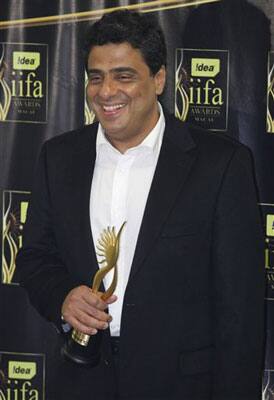 Indian producer Ronnie Screwala celebrates with the trophy after winning the Best Picture award for his movie 