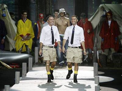 Canadian designers Dean Caten, left, and Dan Caten take the catwalk at the end of their Dsquared2 Spring/Summer 2009/2010 men's collection, presented in Milan, Italy, Tuesday, June 23, 2009.