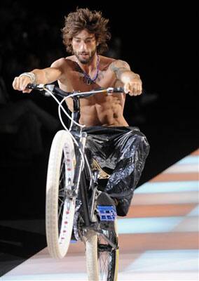 A biker performs on the runway during the Emporio Armani Spring/Summer 2009/2010 men's collection, presented in Milan, Italy, Tuesday, June 23, 2009.