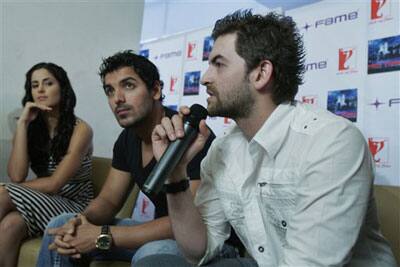 Bollywood actors John Abraham, center, and Katrina Kaif, left, look on as their co-star Neil Nitin Mukesh speaks during a promotional event of their upcoming movie 'New York' in Bangalore, India, June