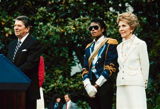 In this May 14, 1984, file photo, Michael Jackson , center, stands with President Ronald Reagan, left, and first lady Nancy Reagan on the south lawn of the White House prior to receiving an award from