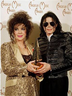 In this Jan. 25, 1993 file photo, Pop singer Michael Jackson, right, holds his award while posing with actress Elizabeth Taylor at the 20th American Music Awards held at the Shrine Auditorium in Los A