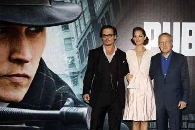 Johnny Depp and Cotillard and director Mann at the premiere of the movie 'Public Enemies' in Paris.