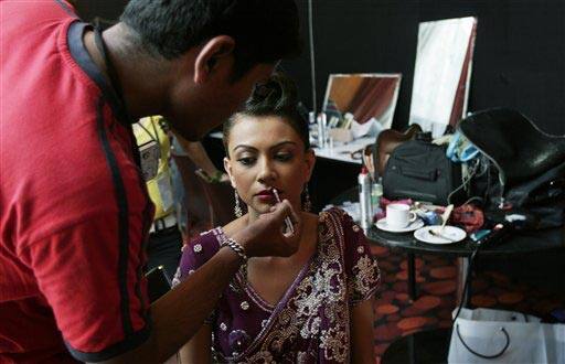 A makeup artist gets a model ready backstage at the Bangalore Fashion Week 2009, in Bangalore, India.