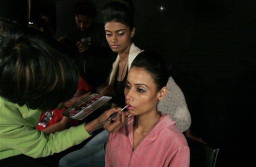 A makeup artist gets a model ready backstage at the Bangalore Fashion Week 2009, in Bangalore, India.