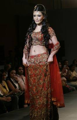 Bollywood actor Koena Mitra, right, displays a creation by Priyanka Thakur at the Bangalore Fashion Week 2009,.