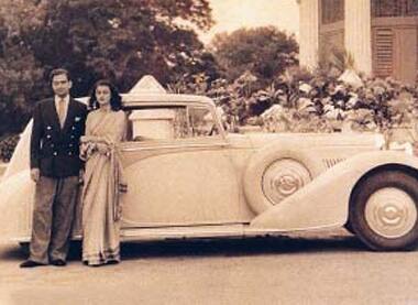 Maharani stands with husband Sawai Man Singh II in front of their palace.