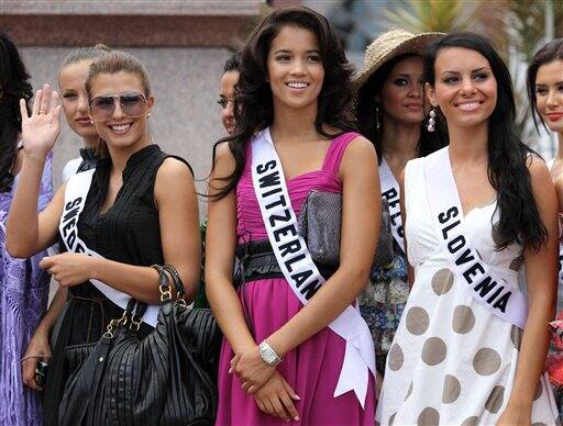 Contestants of the Miss Universe 2009 beauty pageant, from left, Miss Sweden Renate Cerljen, Miss Switzerland Whitney Toyloy and Miss Slovenia Mirela Korac pose for a picture in downtown Nassau, Baham