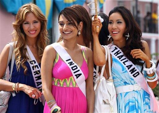 Contestants of the Miss Universe 2009 beauty pageant, from left, Miss Germany Martina Lee, Miss India Ekta Chowdhry and Miss Thailand Chutima Durongdej pose for a picture in downtown Nassau, Bahamas.