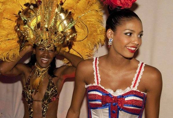 Miss Bahamas 2009 Kiara Sherman and Miss France 2009 Chloe Mortaud (R) prepare backstage for a National Costume show at a hotel in Nassau, Bahamas