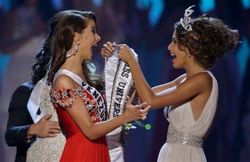 Miss Venezuela Stefania Fernandez, left, reacts as Miss Universe 2008 Dayana Mendoza, also of Venezuela