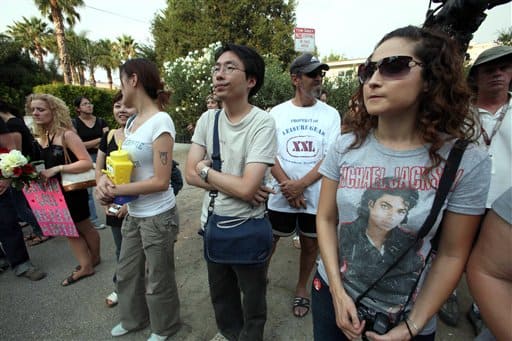 Michael Jackson fans stand outside the Jackson family residence in the Encino section of Los Angeles