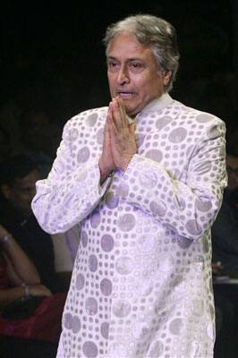 Indian classical Sarod, a stringed musical instrument, maestro Amjad Ali Khan, gestures as he displays an outfir by designer Zubair Kirmani