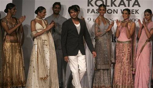 Designer Rocky S, white trousers, comes to catwalk as models wearing his designed outfits during Kolkata Fashion Week in Calcutta,