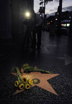 A videographer tapes Patrick Swayze's star on the Hollywood Walk of Fame in Los Angeles, Monday