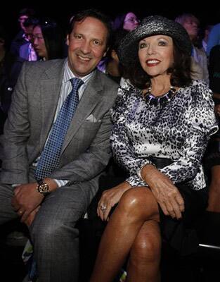 British actress Joan Collins and husband Percy Gibson are seen before the start of the fashion show by British designer Caroline Charles during London Fashion Week, in London