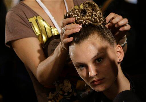 A model is prepared backstage prior to the British designer Paul Smith's show at London Fashion Week in London