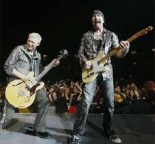 Lead guitarist The Edge and bass guitarist Adam Clayton of U2 perform during the first of two concerts at Giants Stadium in East Rutherford, New Jersey.