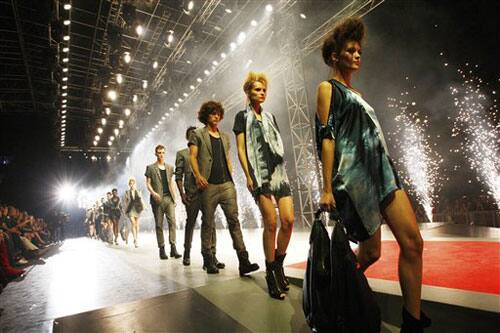 Models wear a creations part of the C'N'C Costume National women's Spring/Summer 2010 fashion collection, presented in Milan's Piazza del Duomo square.