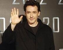 John Cusack waves at a media event announcing his new film '2012'.