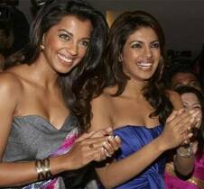 Mughda Godse and Priyanka Chopra smile during the music launch ceremony of their forthcoming movie ‘Jail’ at a multiplex in Mumbai.