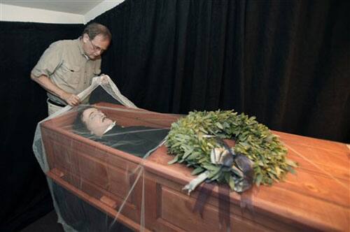 Jeff Jerome, curator of the Poe House and Museum looks over a replica of the body of Edgar Allan Poe, in Baltimore