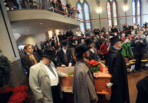 Pall bearers enter Westminster Hall in Baltimore with a casket during a reenactment of author Edgar Allan Poe's funeral 