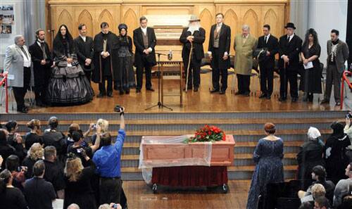 A cast of actors, authors and scholars assemble on stage at Westminster Hall in Baltimore during a reenactment of author Edgar Allan Poe's funeral