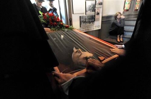 Pall bearers take a casket out of Westminster Hall in Baltimore at the end of a reenactment of author Edgar Allan Poe's funeral 