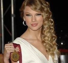 Recording artist Taylor Swift holds her song writing award.