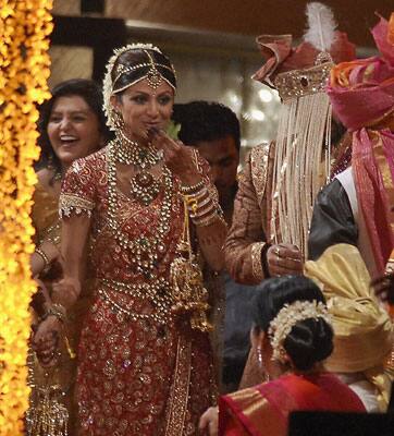 The groom was sporting a maroon sherwani with golden embroidery and a turban with his face veiled by a sehra (string of pearls). He was also holding a sword in his hand, as per Indian tradition.