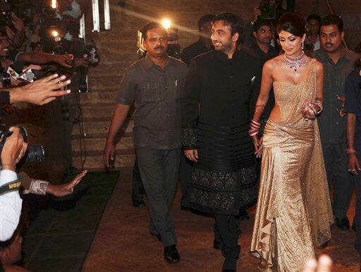 Bollywood actress Shilpa Shetty, second right, and her husband Raj Kundra, canter, arrive to host their wedding reception in Mumbai.