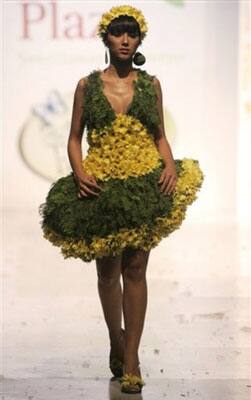 A model showcases a creation made of leaves and flowers by designer Angela Aponte during the Bio Fashion show in Colombia.