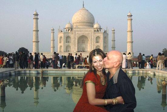 British actor Ben Kingsley (R) kisses his wife Daniela during their visit at the historic Taj Mahal in the northern Indian city of Agra