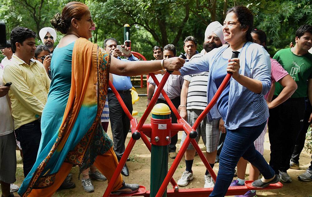 BJP MP Meenakshi Lekhi works out with a morning walker during the inauguration of an open gymnasium at the Lodhi Garden in New Delhi.