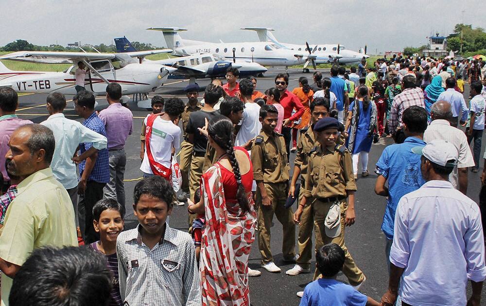 People witness static display of aircrafts at an aero-modelling show organized to mark the 110th birth anniversary of Bharat Ratna J R D Tata at Sonari aerodrum in Jamshedpur.