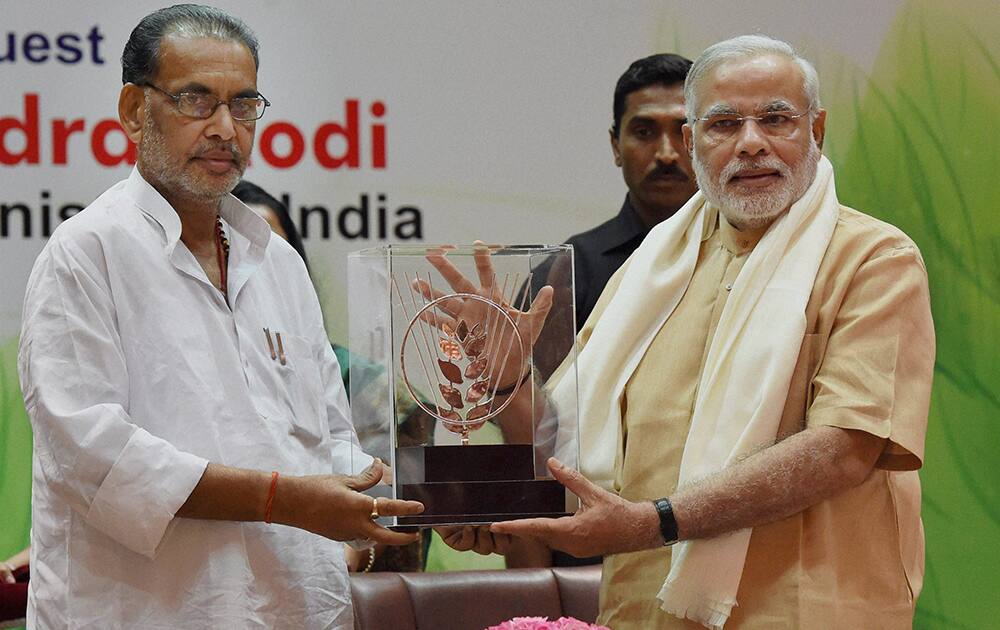 Prime Minister Narendra Modi is presented a memento from Union Agriculture Minister Radha Mohan Singh during the 86th ICAR Foundation Day function in New Delhi.