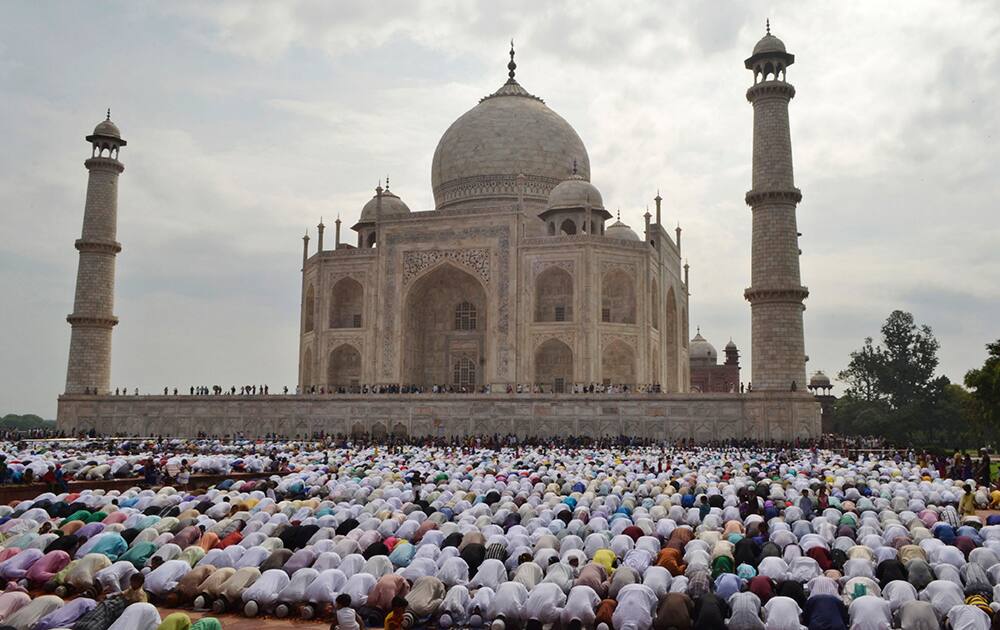 Muslims offer prayers at a mosque in the premises of the Taj Mahal in Agra. Millions of Muslims across the world are celebrating the Eid al-Fitr holiday, which marks the end of the month-long fast of Ramadan.