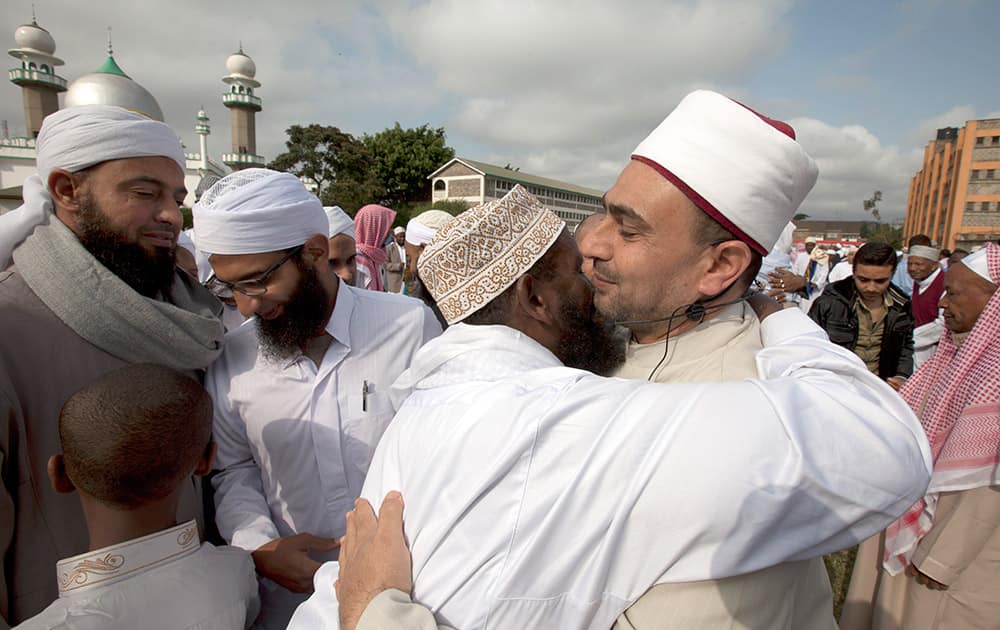 Hundreds of Kenyan Muslims embrace eachother outside Masjid Noor mosque after the end of the holy fasting month of Ramadan in Nairobi, Kenya.