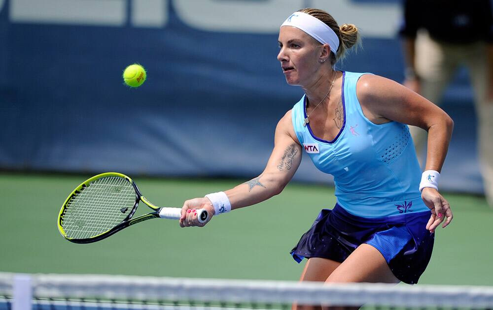 Svetlana Kuznetsova, of Russia, returns the ball against Polona Hercog, of Slovenia, during a match in the Citi Open tennis tournament.