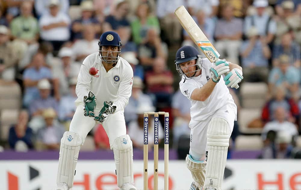 England`s Ian Bell hits a shot as India`s captain and wicketkeeper Mahendra Singh Dhoni, left, watches during the second day of the third cricket test match of the series between England and India at The Ageas Bowl in Southampton, England.