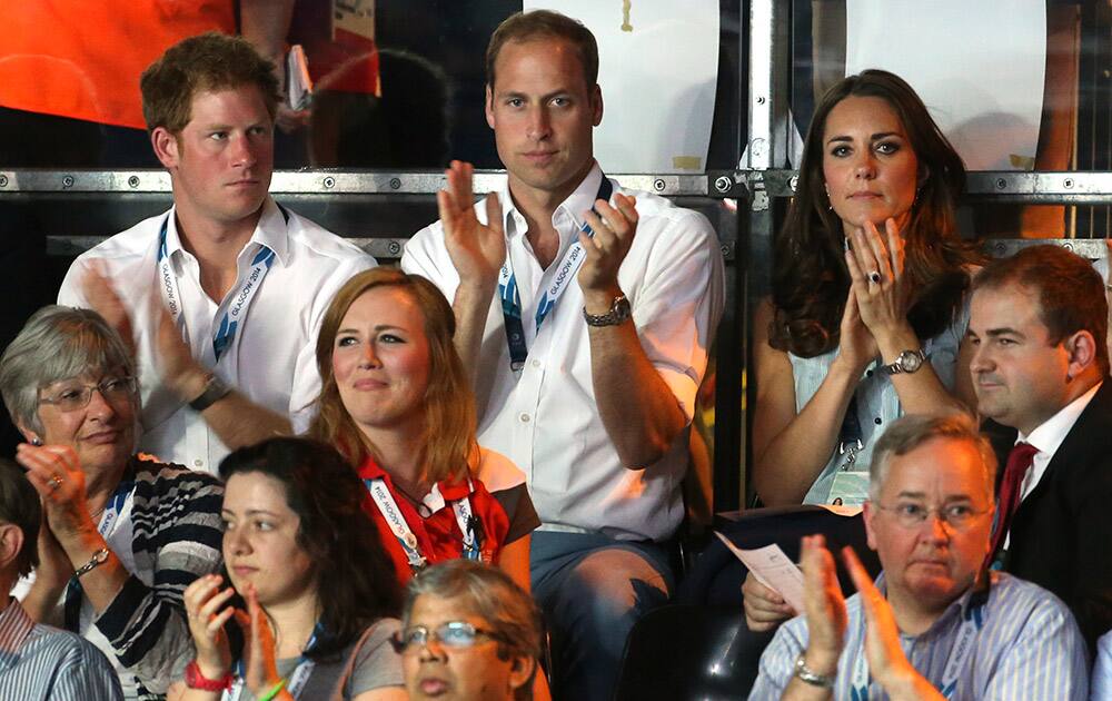 Britain`s Prince William,top centre, sits next to his wife Kate, Duchess of Cambridge and Prince Harry applaud as they watch boxing bouts at the Commonwealth Games Glasgow 2014, in Glasgow.