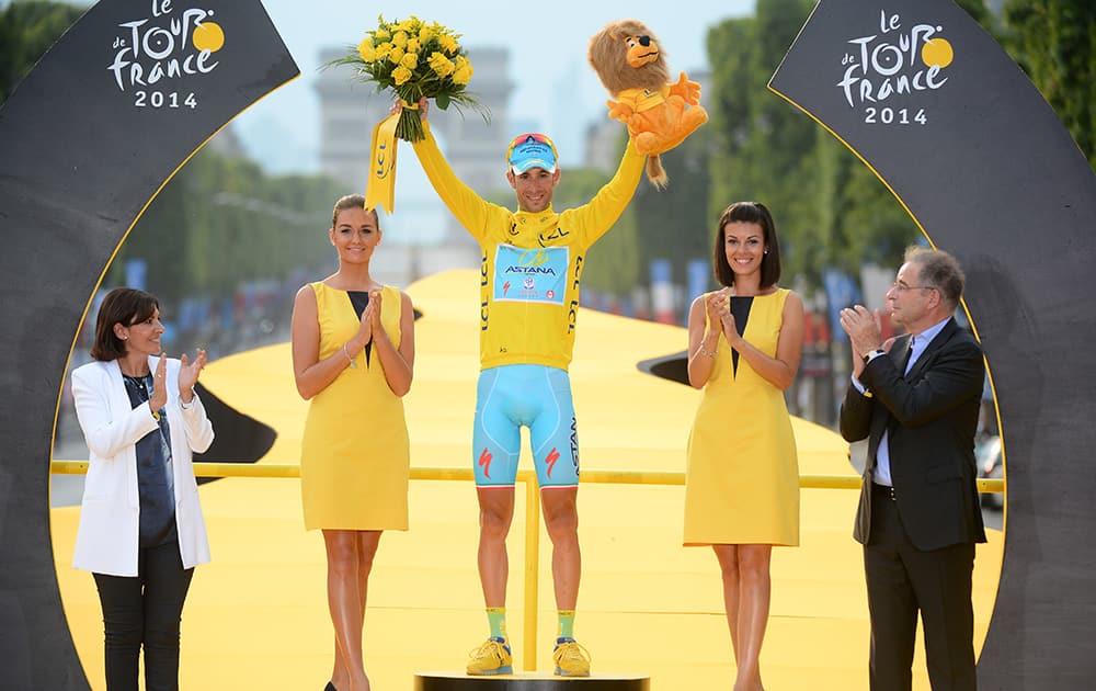Race winner Vincenzo Nibali of Italy, wearing the overall leader`s yellow jersey, celebrates on the podium of the Tour de France in Paris, France.