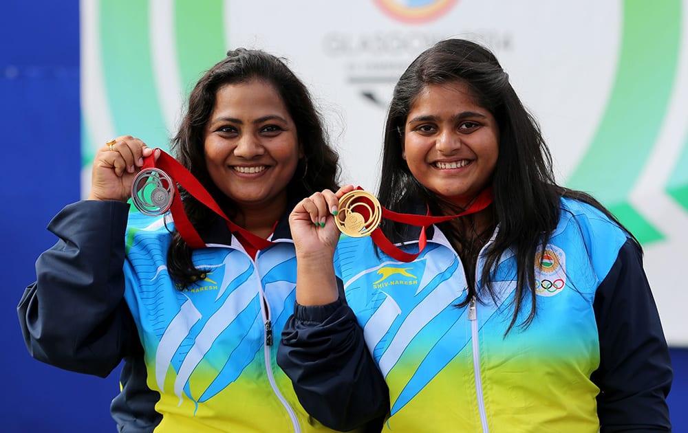 India`s gold medallist Rahi Sarnobatat, right, and silver medallist Anisa Sayyed pose for photographers following the 25m Pistol Women event at the Barry Buddon Shooting Centre in Carnoustie, Scotland, during the Glasgow 2014 Commonwealth Games.