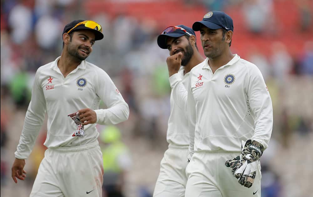 Virat Kohli, spinner Ravindra Jadeja and captain and wicketkeeper Mahendra Singh Dhoni walk off the field of play at the end of the first day of the third cricket test match of the series between England and India at The Ageas Bowl in Southampton, England.